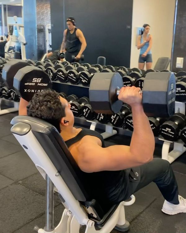 Josh pressing heavy dumbbells on an incline bench